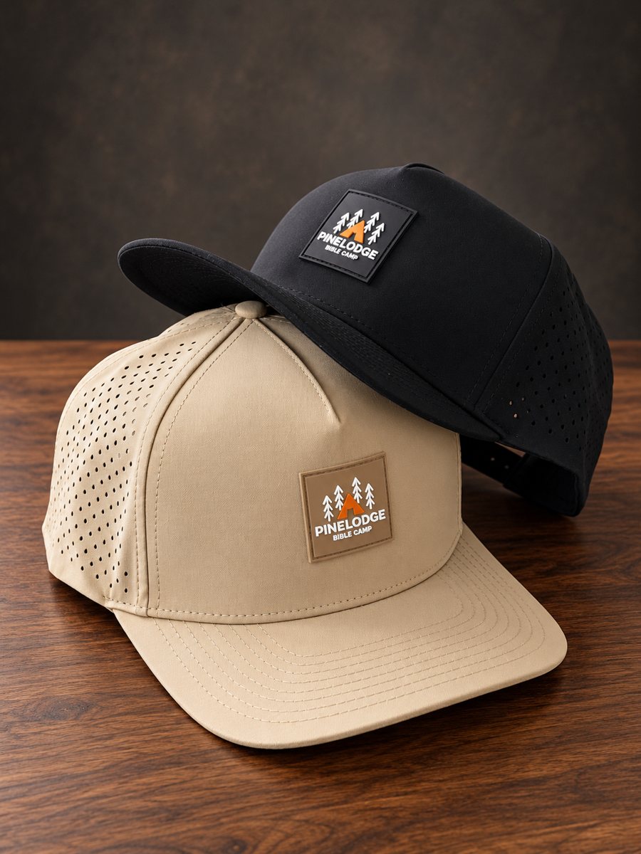Two Pinelodge Bible Camp hats, black and tan, with rubber logo patches